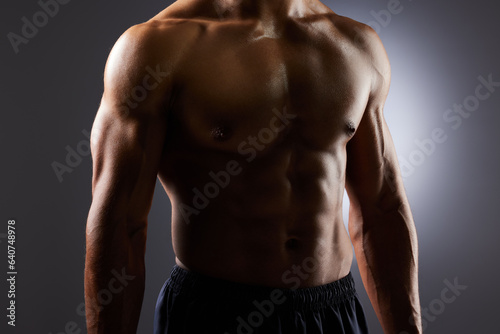 Topless  muscle and torso of man in dark background for fitness inspiration  beauty aesthetic or strong body. Shadow aesthetic  male sports model or muscular body builder in studio with art lighting.