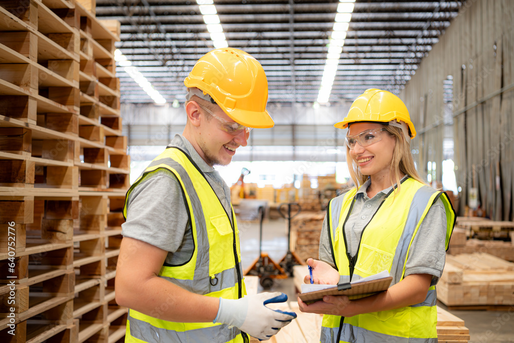 Both of workers work in a woodworking factory, Checking inventory the wood in the wooden warehouse Both of workers work in a woodworking factory, Checking inventory the wood in the wooden warehouse