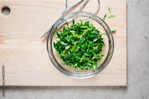Bowl of green myrtle leaves.