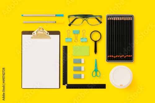 Stationary, school supplies flat lay on yellow background photo