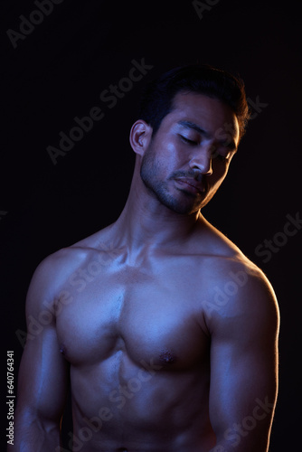 Topless, dark and sexy man on black background in fitness inspiration, beauty aesthetic or strong fantasy. Bodybuilder art, body and seductive male model with muscle, studio and neon blue lighting
