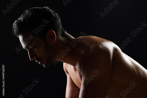 Exercise, strong and studio man doing push up challenge, gym fitness routine and workout for muscle building. Dark shadow light, body training development and calm sports athlete on black background
