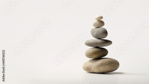 Minimalistic stone arrangement representing Zen philosophy. Balanced stones evoke peace and harmony, symbolizing inner stillness and meditation. Neutral beige color tones. Copy space