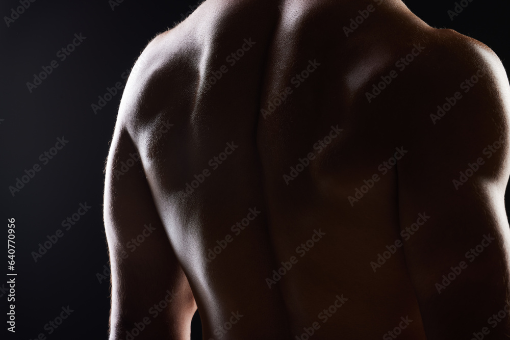 Strong back, dark studio and person with ripped body, fitness transformation goals and muscle building results. Bodybuilder training exercise, shadow light and muscular athlete on black background Strong back, dark studio and person with ripped body, fitness transformation goals and muscle building results. Bodybuilder training exercise, shadow light and muscular athlete on black background