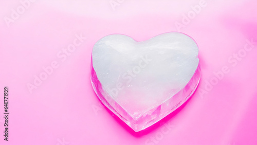 Heart shaped ice cube on pink background. Valentines Day concept. love and romance