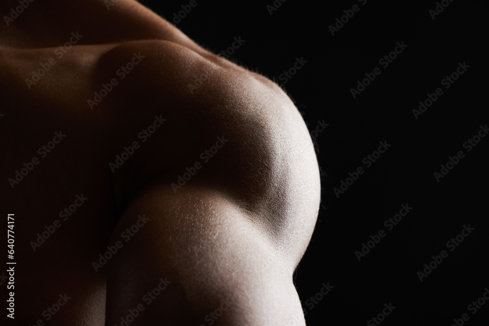 Fototapeta premium Shoulder, closeup and muscle of man in studio isolated on a black background mockup space. Body, strong and arm of model in fitness, bodybuilder power and workout for health, wellness and exercise