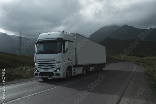 semi truck driving through mountain road pass