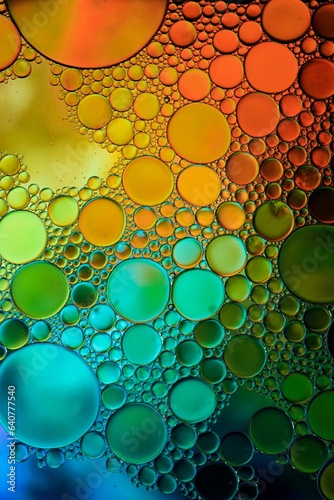 multicolored oil circles on the water, abstract background