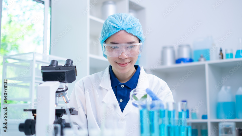 Focused female scientist in laboratory hold plant leaf sample for analysis on biochemistry and biology, a testament in medical botanical research discovery and experiment in chemistry and microbiology