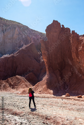woman taking pictures at the rocks of the Valle Arcoiris, Antofagasta, Atacama desert, Chile