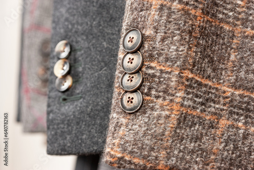 Close up of buttons on a wool jackets. Stylish wool jackets of different colors. Shallow depth of field