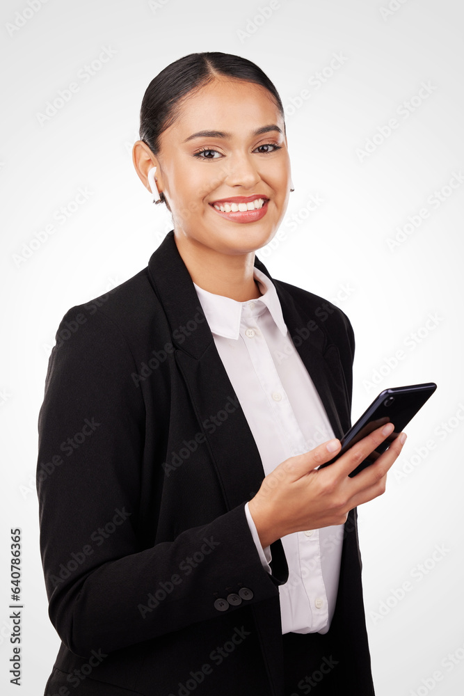 Portrait, phone and earphones with a business woman in studio on a white background for communication. Smile, networking and music with a happy young employee typing a text message on her mobile Portrait, phone and earphones with a business woman in studio on a white background for communication. Smile, networking and music with a happy young employee typing a text message on her mobile