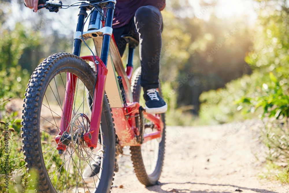 Naklejka premium Nature, cycling and feet with a bicycle for travel, fitness or training on the mountain. Closeup, morning and legs of a person with a bike on a path for a triathlon, exercise or sports adventure