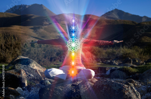 Yoga meditation outdoors. Glowing seven all chakra. Woman sits in a Upward Salute Lotus pose on mountain river view, Kundalini energy. girl practicing.