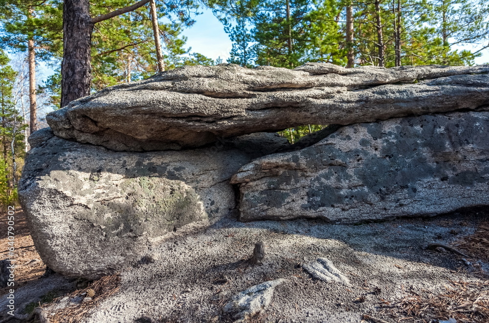 Autumn landscape with trees and rocks on top of a mountain against the sky