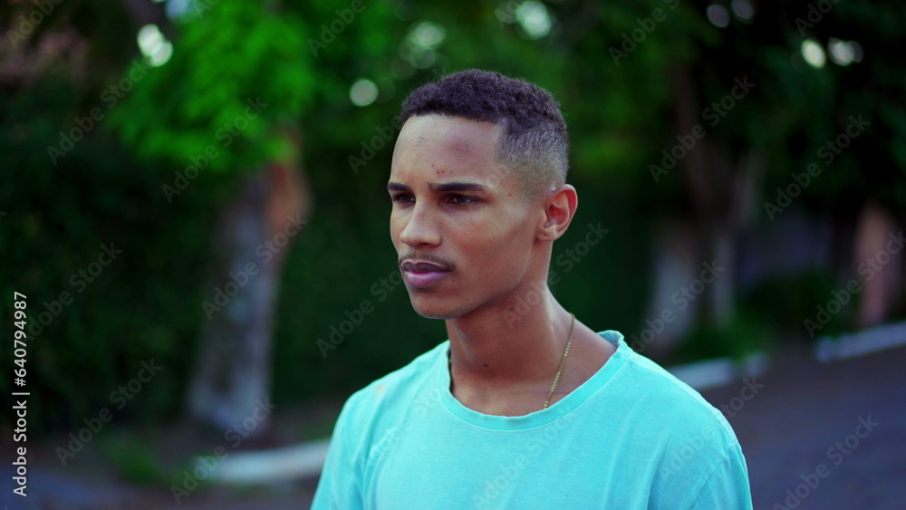 One thoughtful Black Brazilian man walking in street brooding decision. Contemplative African American descent person walks forward pondering dilemma