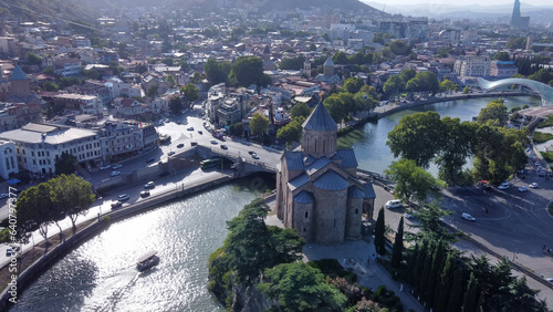 Fantastic view on Kura river , Metkhi Bridge , Metekhi Cathedral and old town of Tboilisi - drone point of  view photo