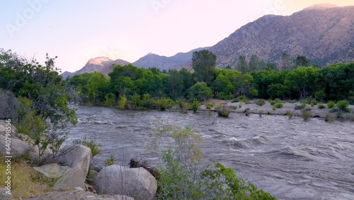 Kernville River flowing heavily with water due to snowpack melt and rains in 2023. Taken in early morning with mountains in the background in Kernville, California. photo