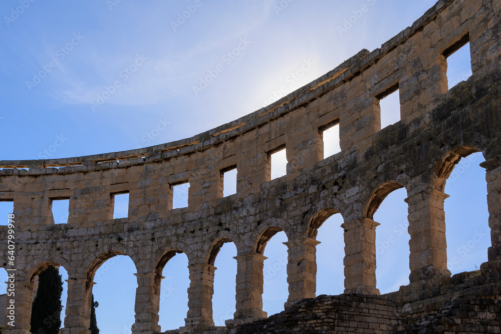The ruins of the Roman arena in the Croatian city of Pula under a blue sky on a sunny day