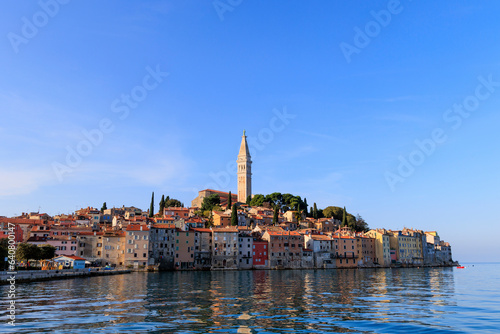 Tower of St. Euphemia Church in Rovinj on the peninsula with the picturesque old town in the light of the sunset