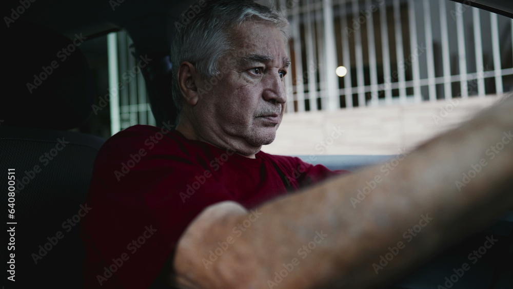 Regretful senior man feeling shame and guilt, remembering trauma from the past, struggling alone inside parked car leaning forward holding into steering wheel Regretful senior man feeling shame and guilt, remembering trauma from the past, struggling alone inside parked car leaning forward holding into steering wheel