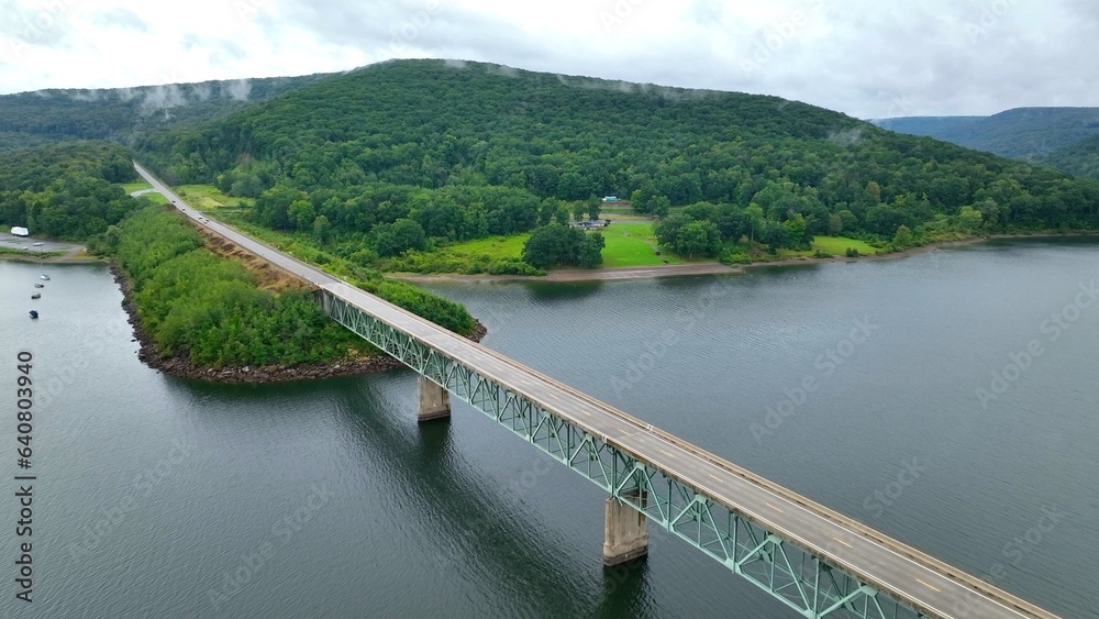 Bridge crossing over Allegheny River beside mountains in National Forest remote wilderness area Bridge crossing over Allegheny River beside mountains in National Forest remote wilderness area