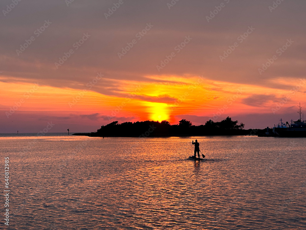 Paddle boarder during sunset in Pamlico Sound