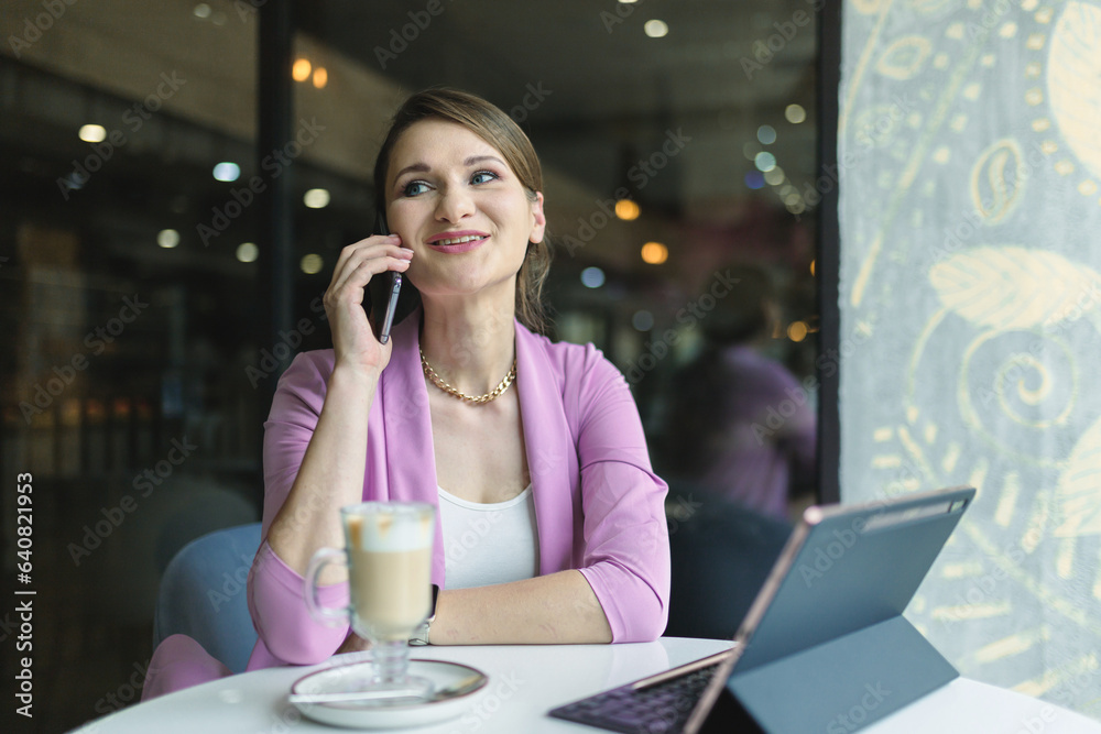 Young happy business woman waiting for a man for a date in a cafe during lunch. Young happy business woman waiting for a man for a date in a cafe during lunch.