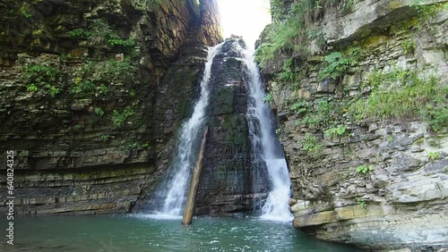 Cascade of the Bukhtivets fall. Landscape of waterfall in the Ukrainian Carpathian Mountains. The water flows beautifully over the rocks. Mountain river. Beautiful big waterfall in the mountains. photo