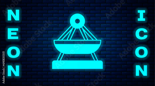 Glowing neon Boat swing icon isolated on brick wall background. Childrens entertainment playground. Attraction riding ship, swinging boat. Amusement park. Vector