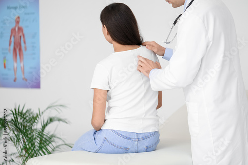 Male doctor checking postur...