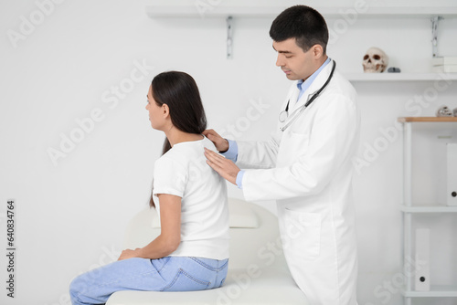 Male doctor checking postur...