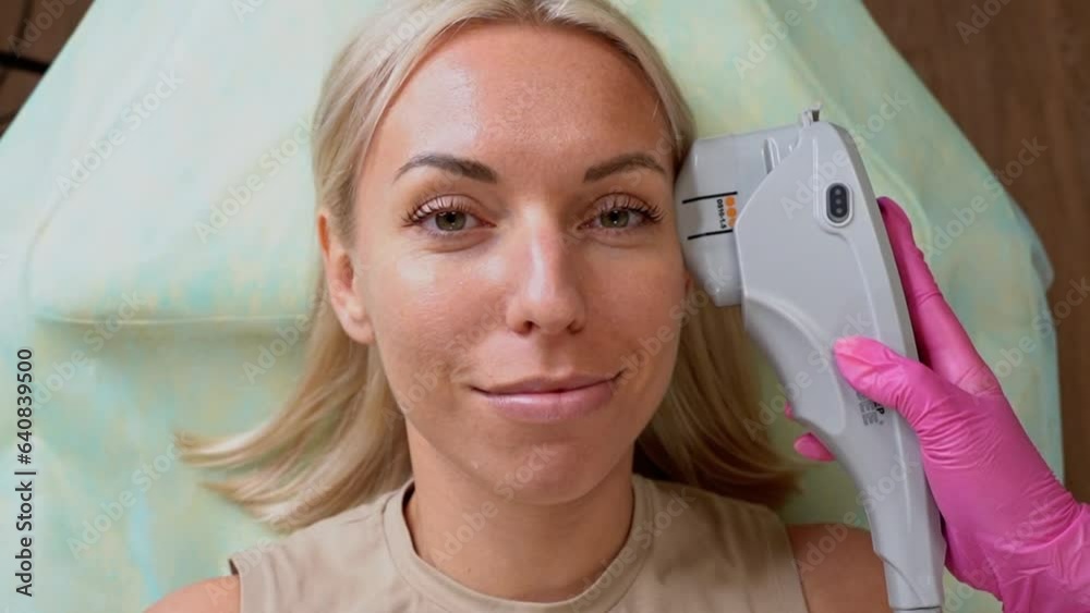 Woman with diode laser hair removal equipment for epilation, tattoo removal or carbon peeling