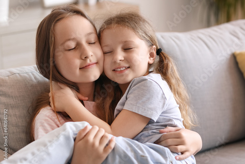 Cute little sisters hugging...