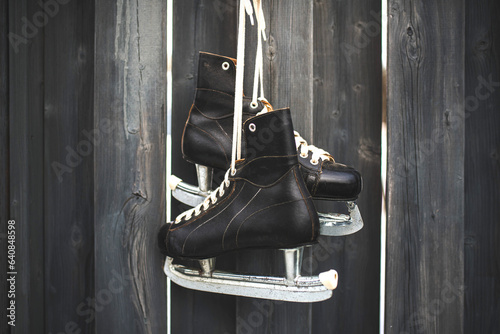 Photography Old vintage leather ice hockey skates hanging on a fence