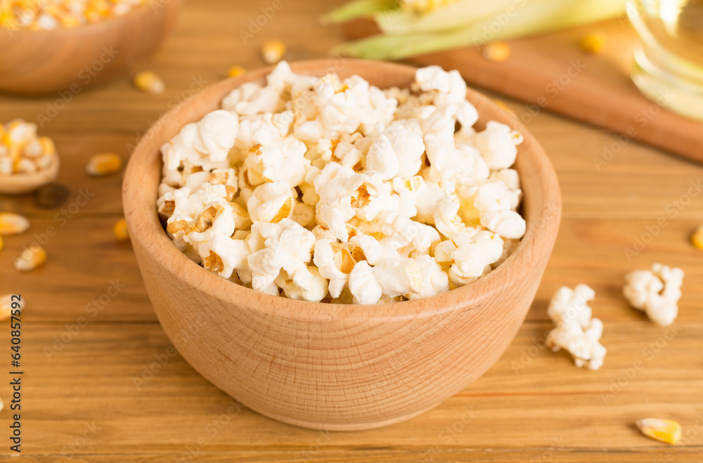 Prepared popcorn with ingredients on wooden table Prepared popcorn with ingredients on wooden table