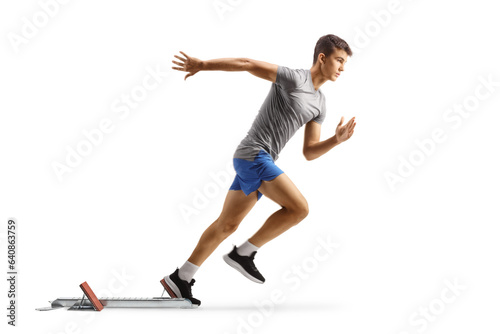 Full length profile shot of a fit young man running from start blocks