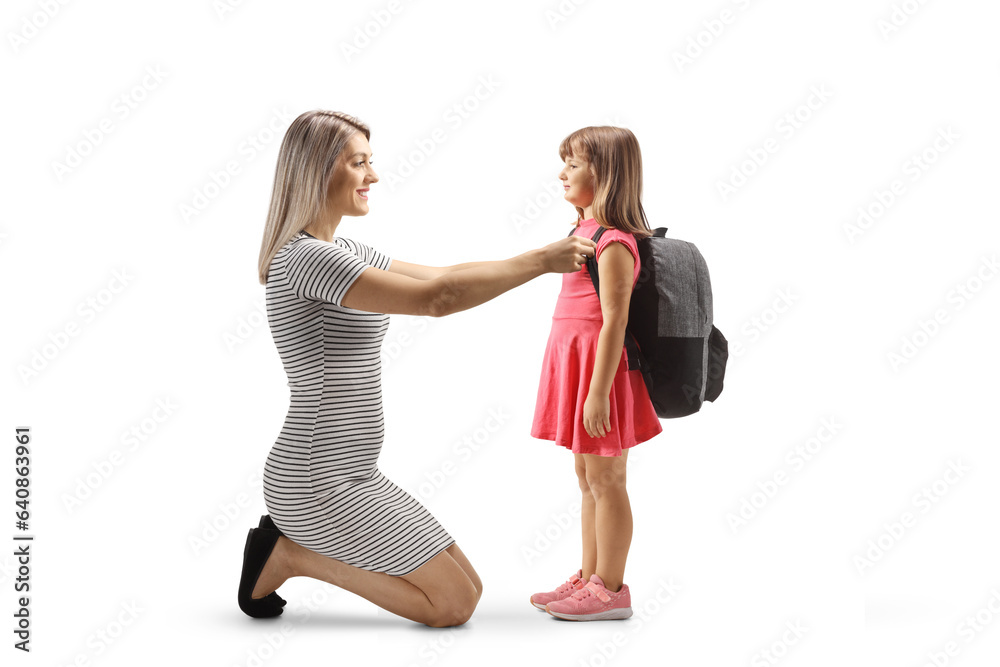 Full length profile shot of a woman helping a girl preparing for school Full length profile shot of a woman helping a girl preparing for school