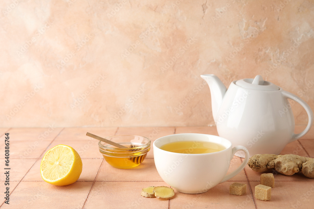 Cup of ginger tea and bowl with honey on pink tile table Cup of ginger tea and bowl with honey on pink tile table