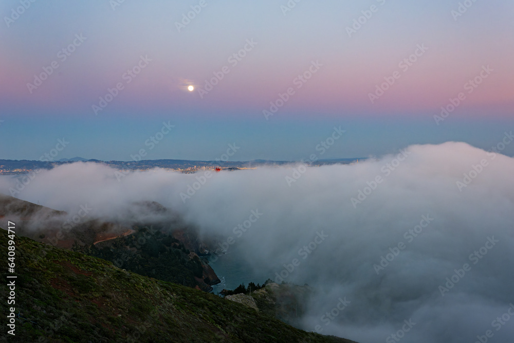 Twilight aerial view of the Golden Gate Bridge with fog