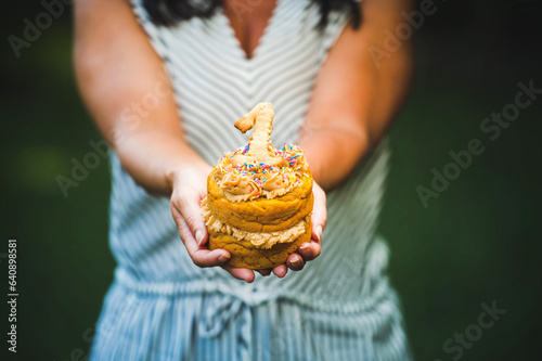Holding a first birthday cupcake