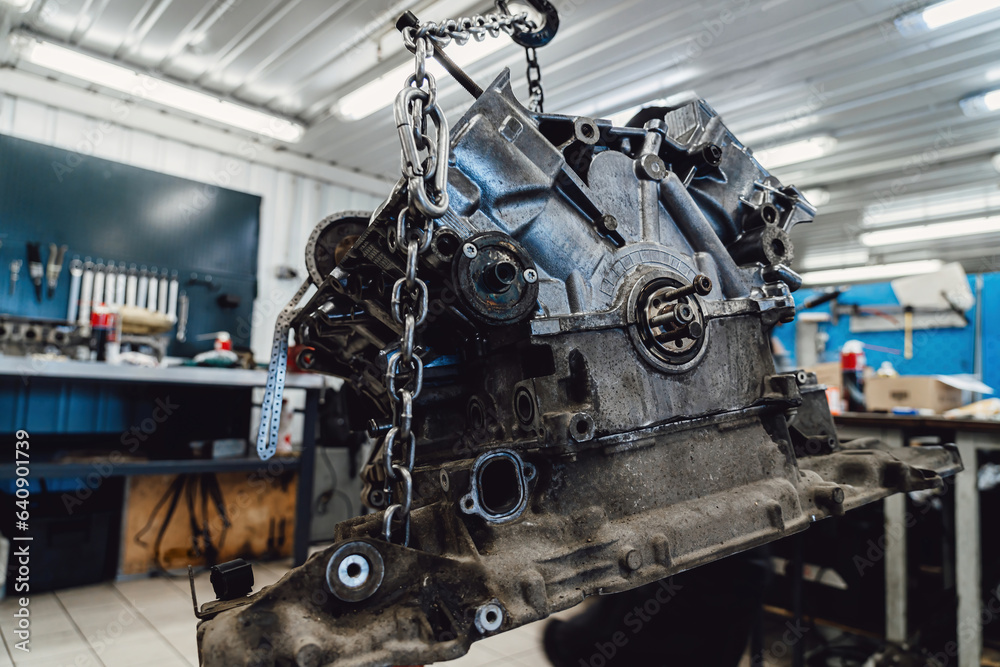 Car engine in a repair shop for overhaul and spare parts replacement. Car engine in a repair shop for overhaul and spare parts replacement.