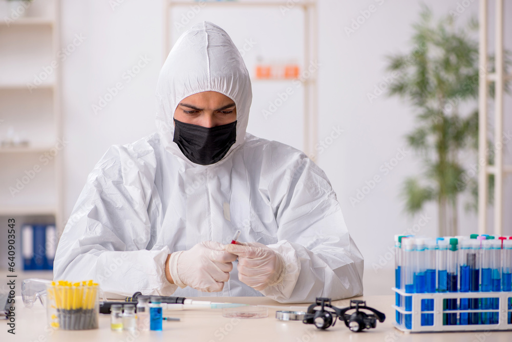 Young male chemist working at the lab during pandemic Young male chemist working at the lab during pandemic