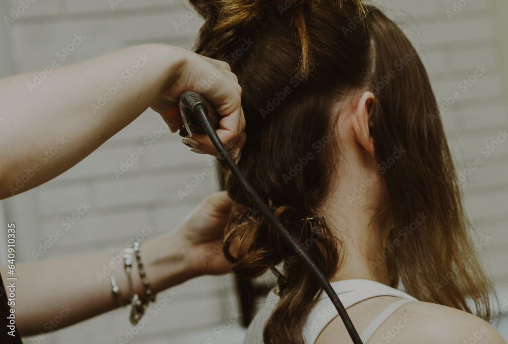 Fototapeta premium Portrait of a young girl at the hairdresser.