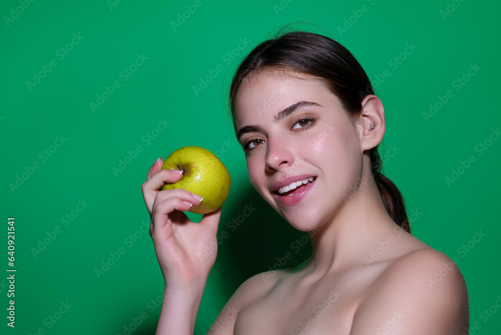 Biting apple concept. Portrait of a young woman eating apple isolated over studio background. Healthy apple fruit, natural vitamin, dieting and vegan. Studio portrait of beauty girl eat green apple. Biting apple concept. Portrait of a young woman eating apple isolated over studio background. Healthy apple fruit, natural vitamin, dieting and vegan. Studio portrait of beauty girl eat green apple.