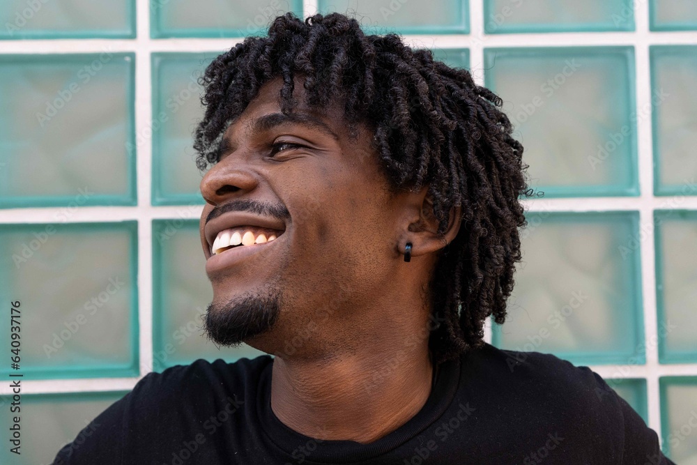 Afro boy with smiling face looking to the side Afro boy with smiling face looking to the side