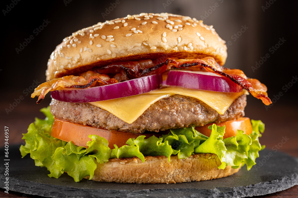 Delicious hamburger with meat, cheese, bacon and salad. Delicious hamburger with meat, cheese, bacon and salad.