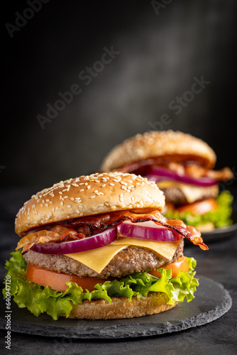 Delicious hamburger with meat, cheese, bacon and salad.