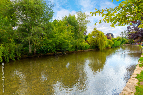 The tranquil River Windrush runs along the picturesque Cotswolds town of Bourton-on-the-Water  England.