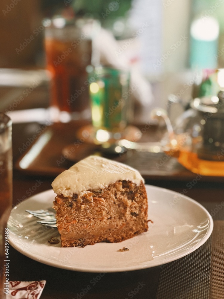 Carrot Cake on a White Plate in a Restaurant Carrot Cake on a White Plate in a Restaurant
